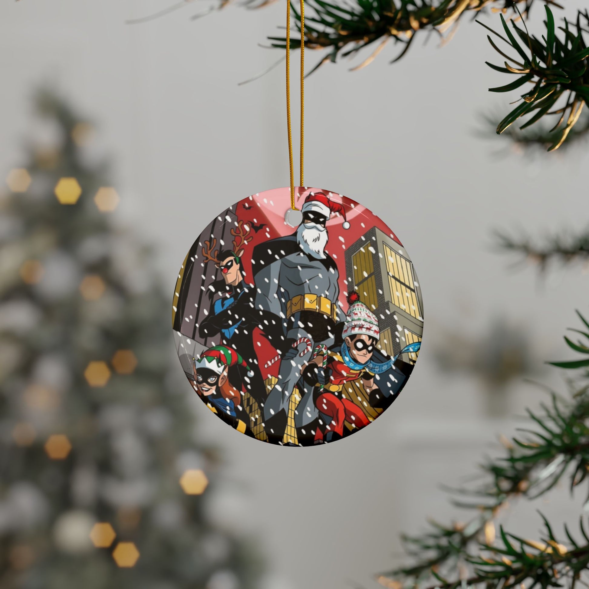 Circular Christmas ornament with Batman design hanging on a tree.