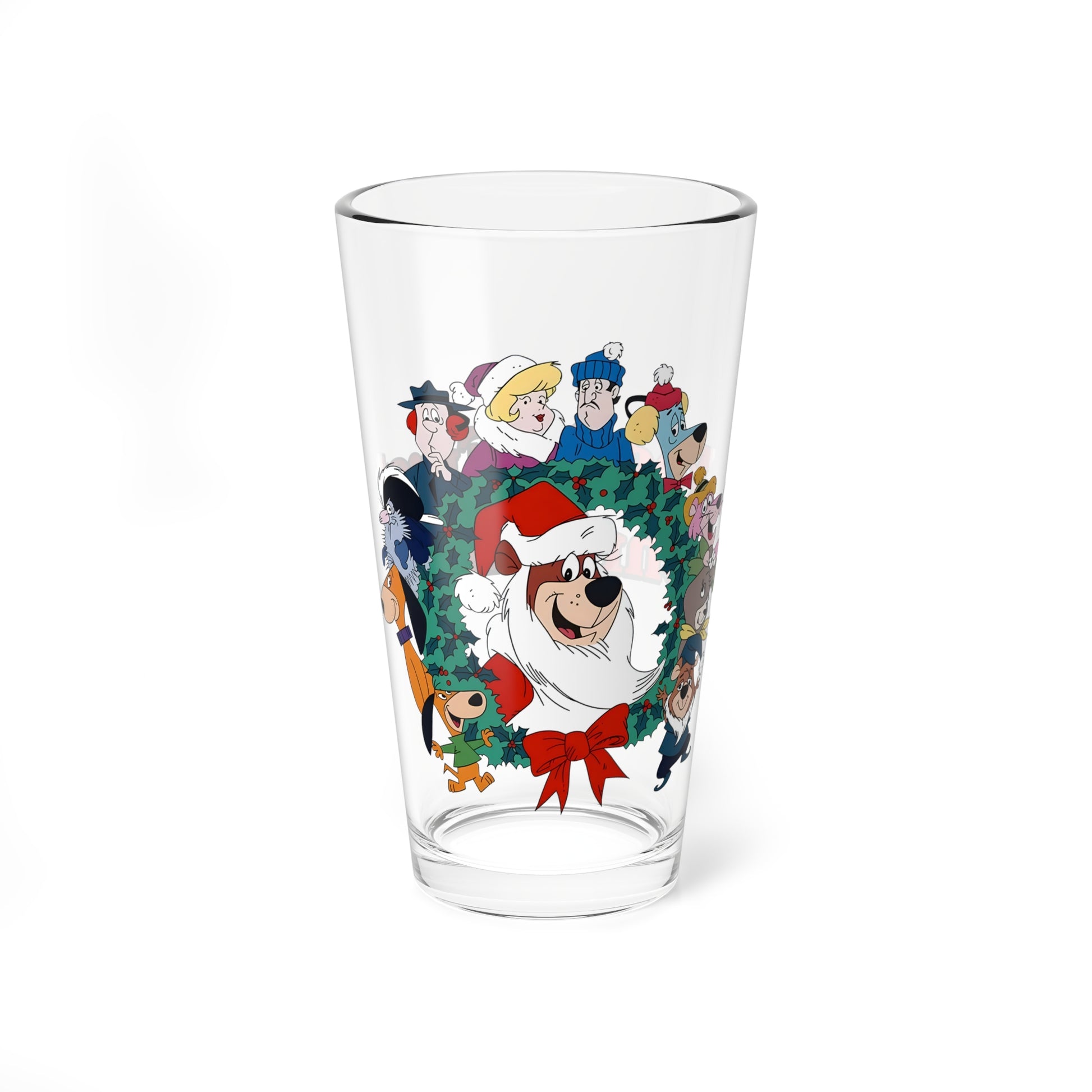 Clear pint glass with Hanna-Barbera characters and a Christmas wreath design on a white background