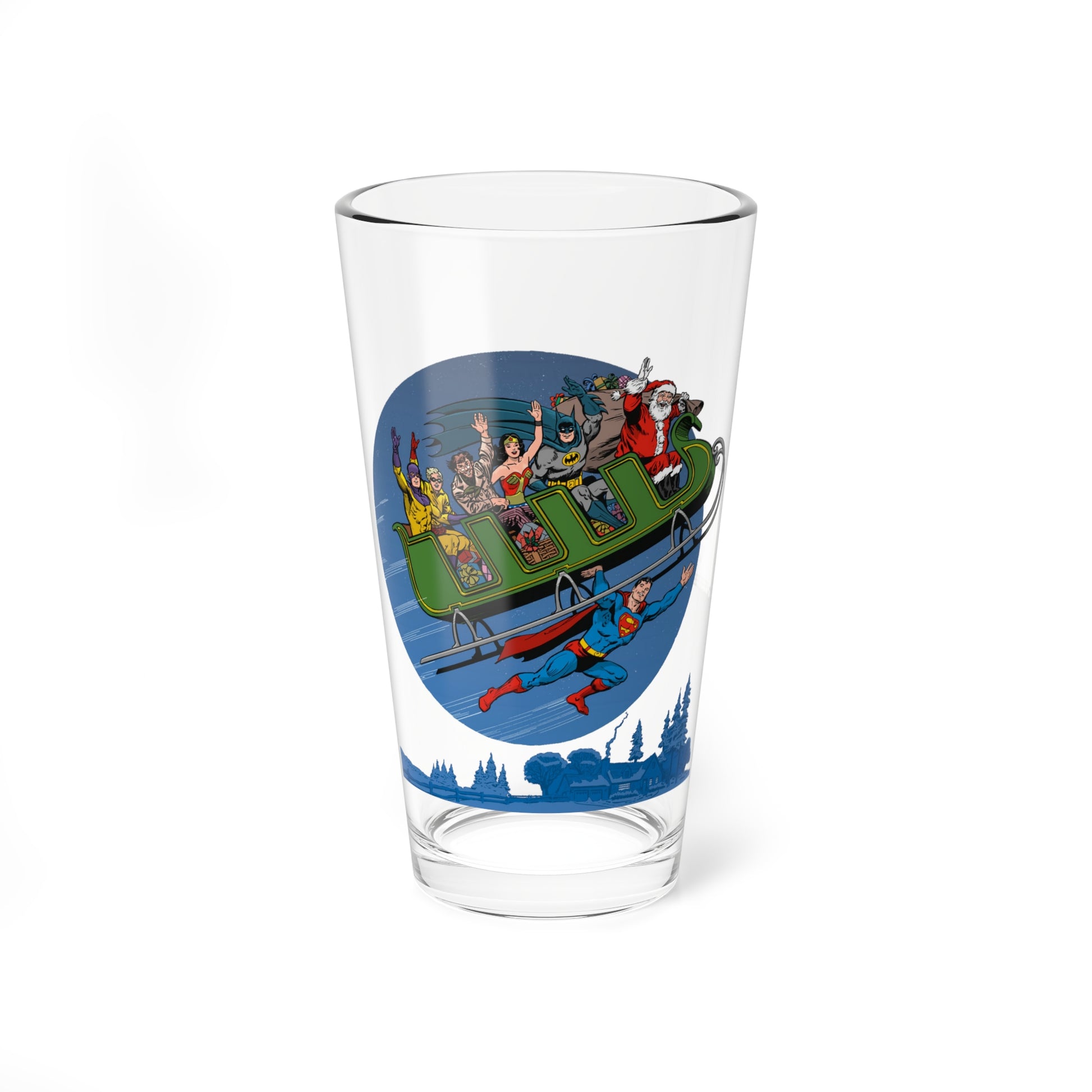 A high-quality pint glass with a great image of Superman flying through the air carrying a sleigh with Wonder Woman, Batman, Sandman, and Santa Claus.