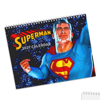 A Superman 2027 spiral-bound calendar shown from two angles on a white background: one angled view displaying Superman artwork and the title, and one flat view showing a blank page with a small cover sticker.